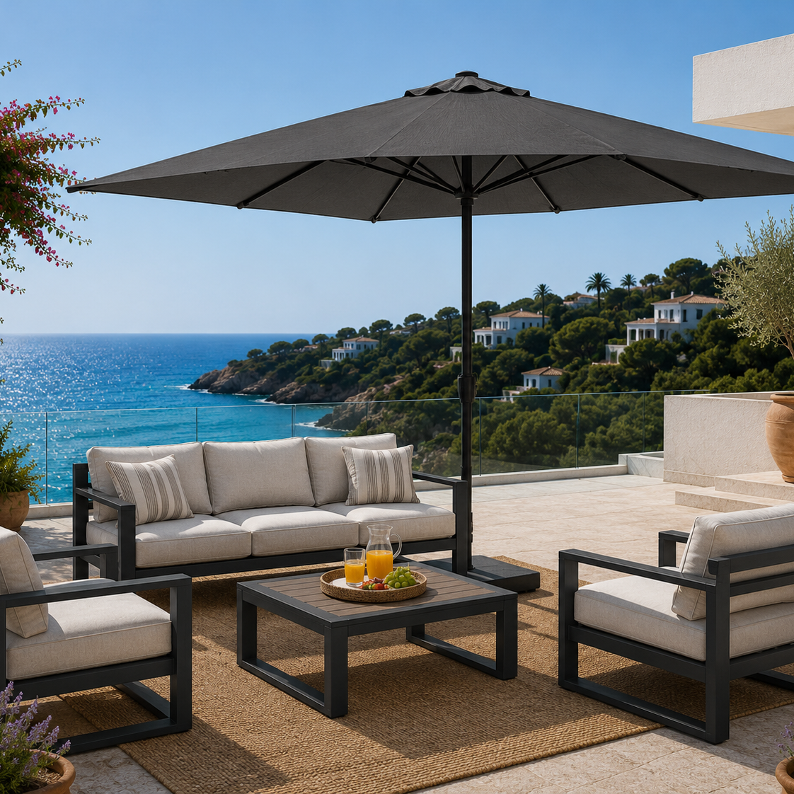 Outdoor patio set with furniture and umbrella overlooking a scenic ocean view.