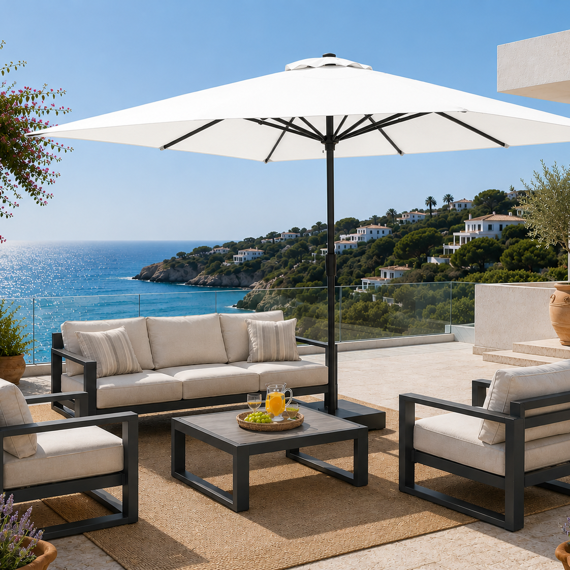 Outdoor patio set with furniture and umbrella overlooking a scenic ocean view.