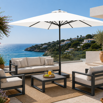 Outdoor patio set with furniture and umbrella overlooking a scenic ocean view.
