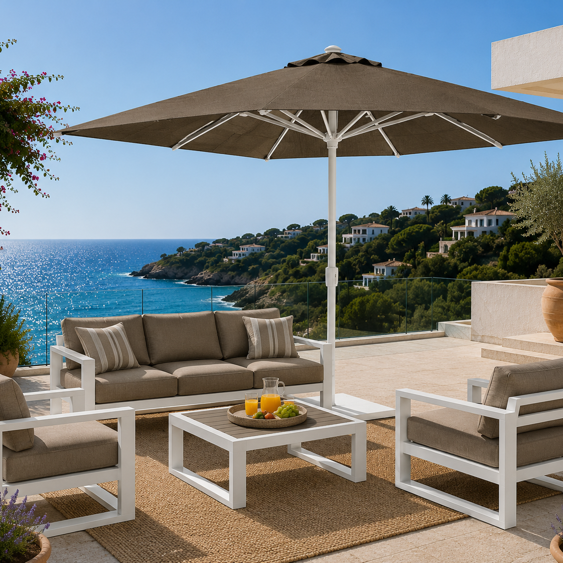 Outdoor patio set with furniture and umbrella overlooking a scenic ocean view.